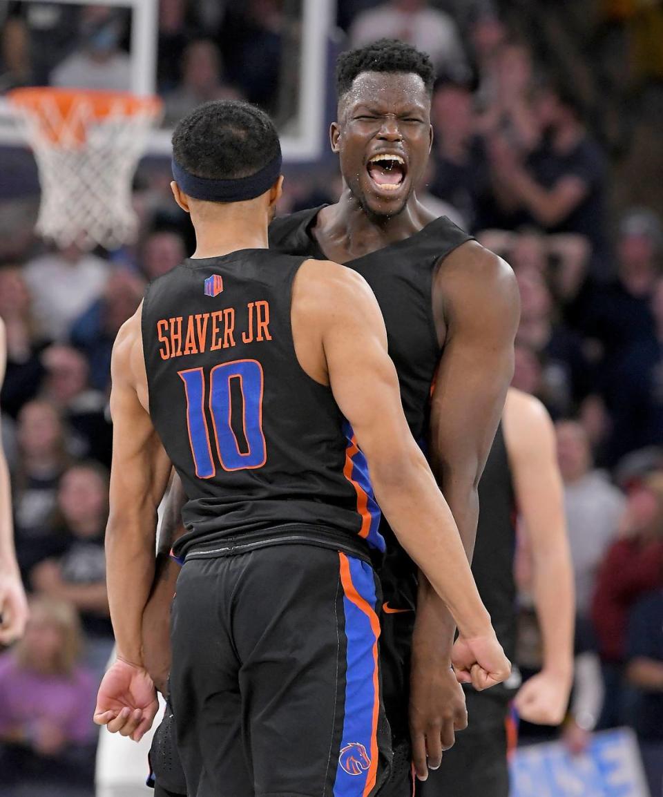 Boise State guards Marcus Shaver Jr. and Emmanuel Akot, facing, celebrate after Shaver made the game-winning 3-pointer to send Boise State to a 62-59 win over Utah State on Thursday at Dee Glen Smith Spectrum in Logan, Utah.