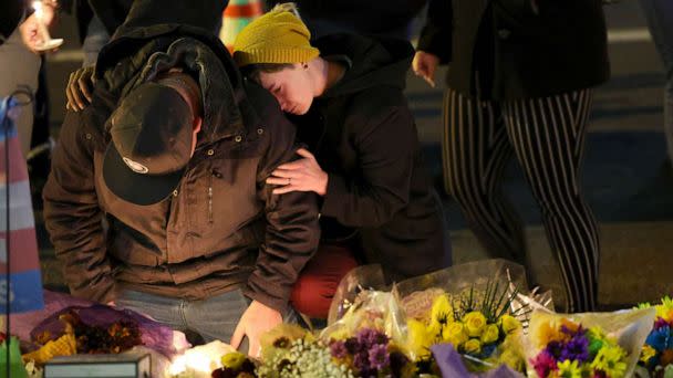 PHOTO: People hold a vigil at a makeshift memorial near the Club Q nightclub, Nov. 20, 2022 in Colorado Springs, Colorado. (Scott Olson/Getty Images)