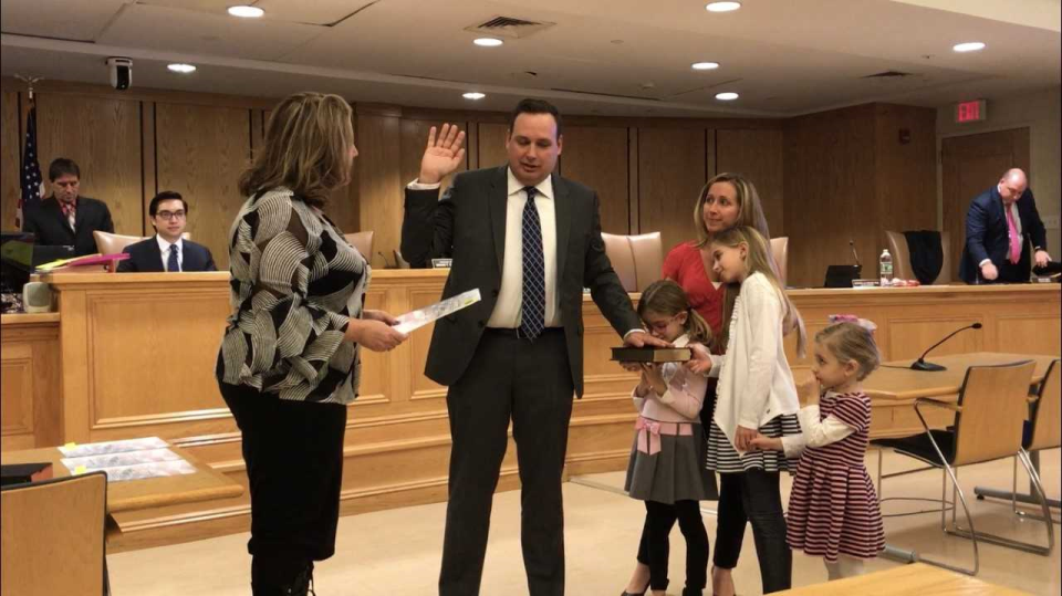Assemblywoman Holly Schepisi swears in Robert Ferguson to his first term as councilman at the Jan. 3 reorganization meeting while wife Mary Manetas and daughters look on.