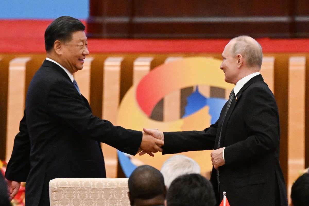 Xi Jinping shakes hands with Vladimir Putin at the Belt and Road summit in the Great Hall of the People in Beijing (AFP via Getty)