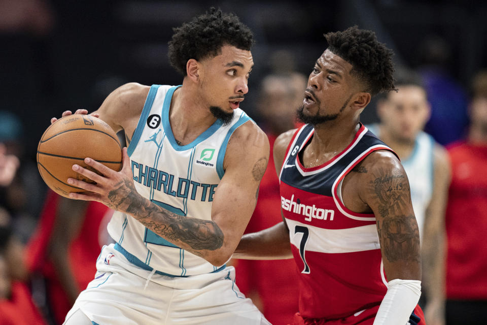 Washington Wizards guard Jordan Goodwin (7) guards Charlotte Hornets guard James Bouknight in the second half of an NBA preseason basketball game in Charlotte, N.C., Monday, Oct. 10, 2022. (AP Photo/Jacob Kupferman)