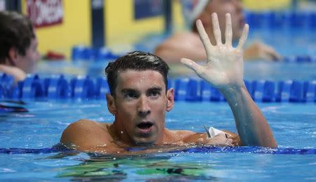 Jun 29, 2016; Omaha, NE, USA; Michael Phelps holds up five fingers during the finals for the men's 200 meter butterfly in the U.S. Olympic swimming team trials at CenturyLink Center. Erich Schlegel-USA TODAY Sports