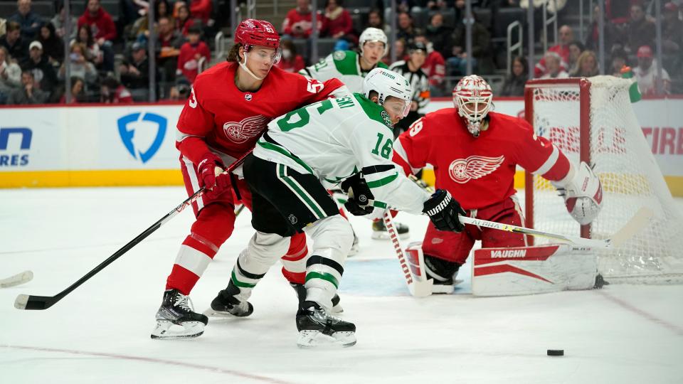 Detroit Red Wings defenseman Moritz Seider (53) knocks Dallas Stars center Joe Pavelski (16) off the puck in the first period of an NHL hockey game Friday, Jan. 21, 2022, in Detroit.