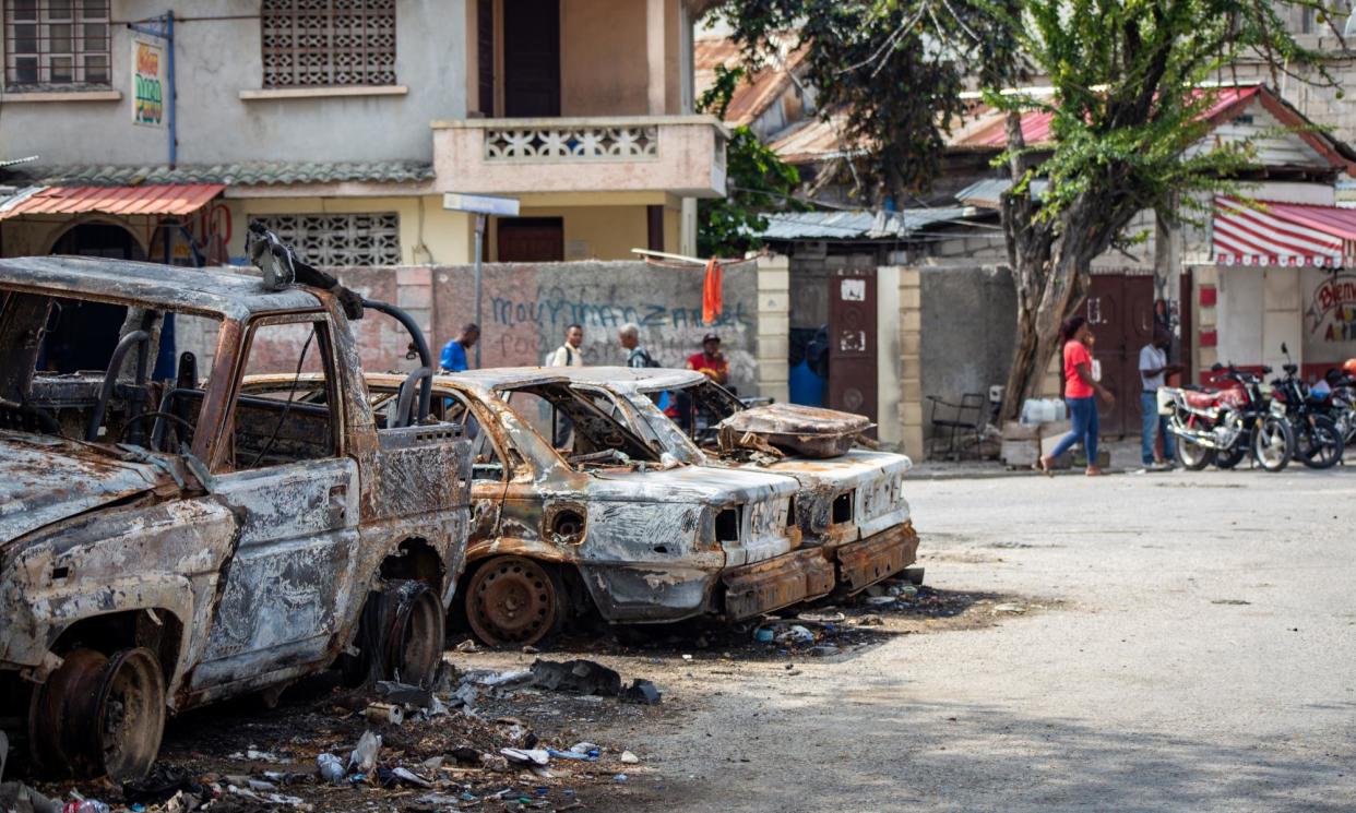 <span>The remnants of burned-out vehicles in Port-au-Prince.</span><span>Photograph: Mentor David Lorens/EPA</span>