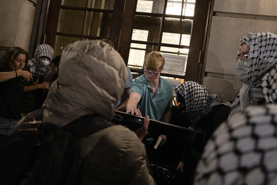 Students try to prevent the Gaza Solidarity Encampment from taking over Hamilton Hall at Columbia University on Tuesday, April 30, in New York. Columbia Students for Justice in Palestine called for mobilization close to midnight before taking over the hall. (Marco Postigo Storel via AP)