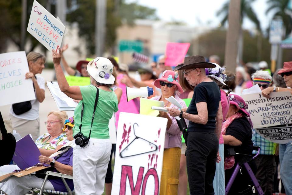 The Democratic Women's Club of Palm Beach County and the Palm Beach County National Organization for Women hold a "Bigger Than Roe" rally on the sidewalk along Palm Beach Lakes Boulevard Sunday January 21, 2023 in Palm Beach.