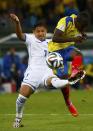 Emilio Izaguirre of Honduras fights for the ball with Ecuador's Enner Valencia (R) during their 2014 World Cup Group E soccer match at the Baixada arena in Curitiba June 20, 2014. REUTERS/Darren Staples (BRAZIL - Tags: SOCCER SPORT WORLD CUP)