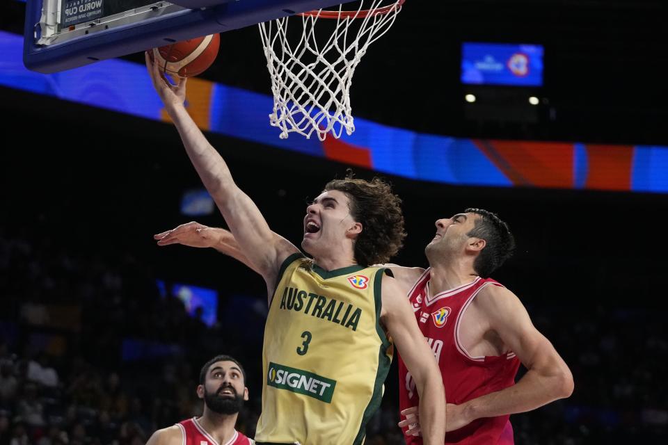 Australia guard Josh Giddey (3) shoots against Georgia center Giorgi Shermadini (9) in the second half of their Basketball World Cup group K match in Okinawa, southern Japan, Sunday, Sept. 3, 2023. (AP Photo/Hiro Komae)