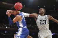 Georgetown forward Josh LeBlanc (23) knocks the ball away from Duke guard Tre Jones (3) during the second half of an NCAA college basketball game in the 2K Empire Classic, Friday, Nov. 22, 2019 in New York. Duke won 81-73. (AP Photo/Kathy Willens)