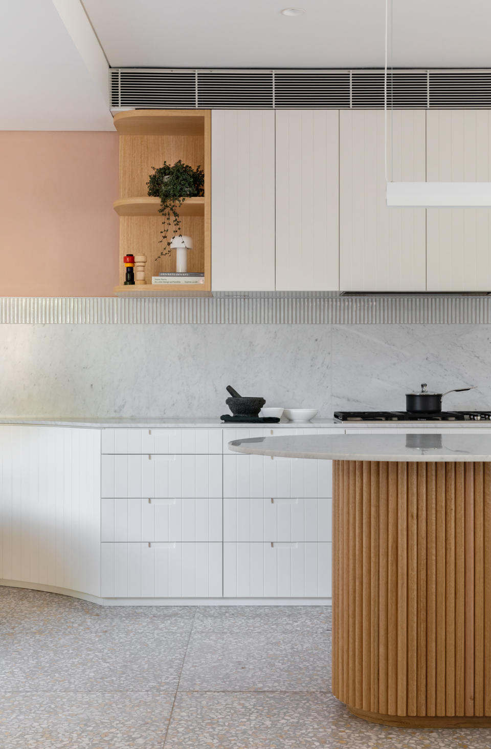 A backsplash with large format marble tiles