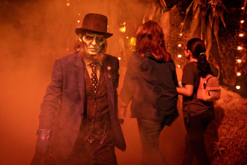 LOS ANGELES, CA - OCTOBER 06: A haunted house actor roams outside the Midnight Falls gate waiting for guest to come ride the Haunted Hayride in Griffith Park on Thursday, Oct. 6, 2022 in Los Angeles, CA. (Jason Armond / Los Angeles Times)