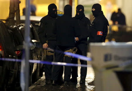 Masked Belgian police secure the entrance to a building in Schaerbeek during police operations following Tuesday's bomb attacks in Brussels, Belgium, March 25, 2016. REUTERS/Christian Hartmann