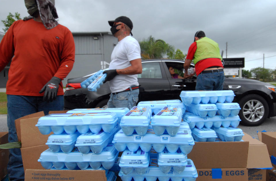 Volunteers distribute eggs from the Second Harvest Food Bank of Central Florida to needy families at a drive through event on April 17, 2020 in Kissimmee, Florida. | Paul Hennessy—NurPhoto/Getty Images