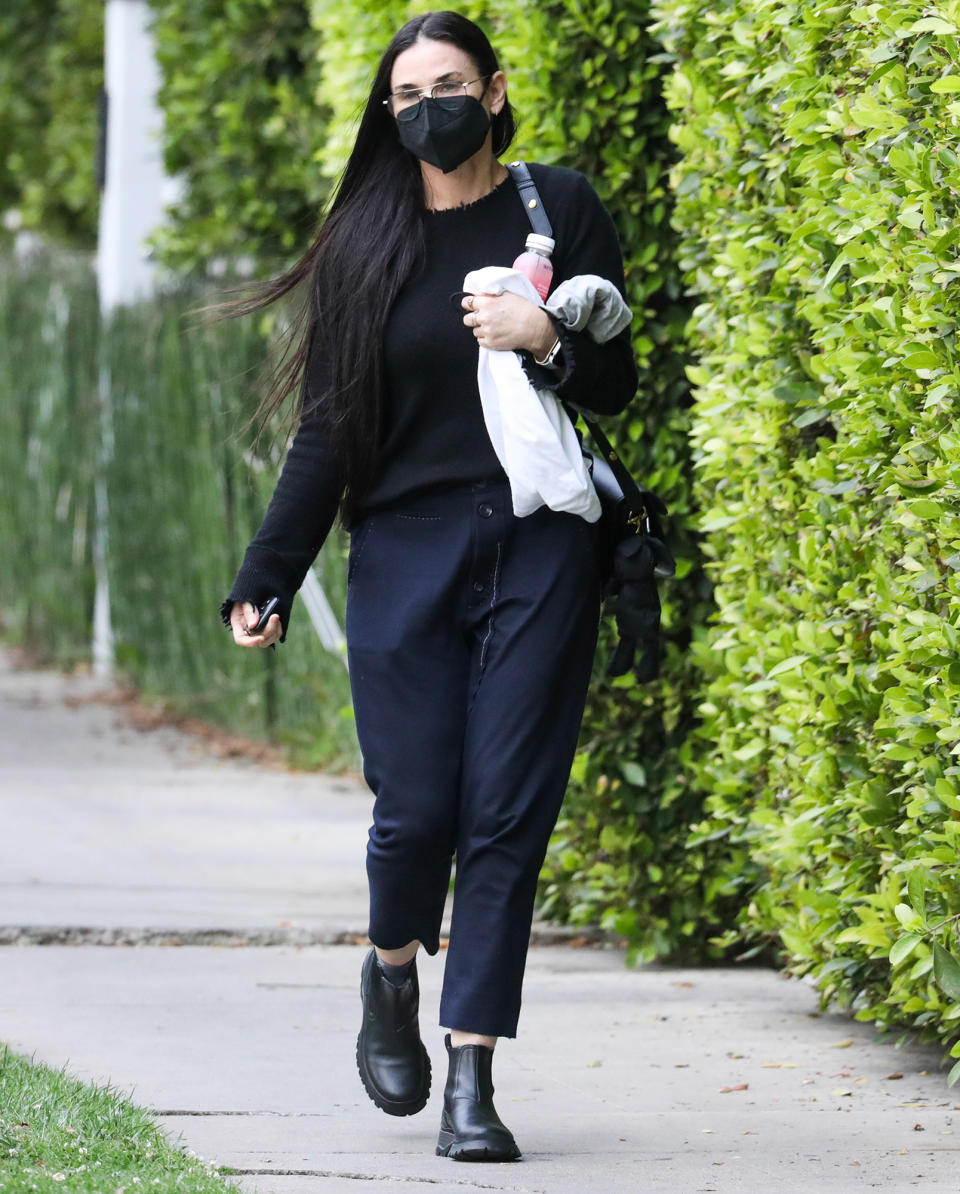 <p>Demi Moore leaves her pilates class in a black mask and matching sweater on Wednesday in L.A.</p>