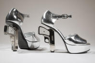 In this undated photo provided by the Fashion Institute of Technology shows a pair of silver shoes designed by Chanel with guns as heels. The shoe is on display at the "Shoe Obsession" exhibit at The Museum at the Fashion Institute of Technology Museum in New York. The exhibition, showing off 153 specimens, runs through April 13. (AP Photo/Fashion Institute of Technology)