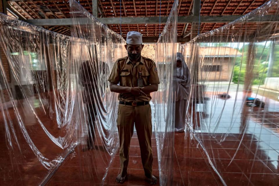 <div class="inline-image__caption"><p>People prayed between plastic separation curtains to prevent the spread of the coronavirus disease (COVID-19) in Semarang, Central Java Province, Indonesia, May 18, 2020.</p></div> <div class="inline-image__credit">Antara Foto Agency/Reuters</div>