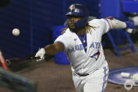 Toronto Blue Jays' Vladimir Guerrero Jr. tries to get to a foul ball with his bat during the eighth inning of a baseball game against the Baltimore Orioles in Buffalo, N.Y., Thursday, June 24, 2021. (AP Photo/Joshua Bessex)