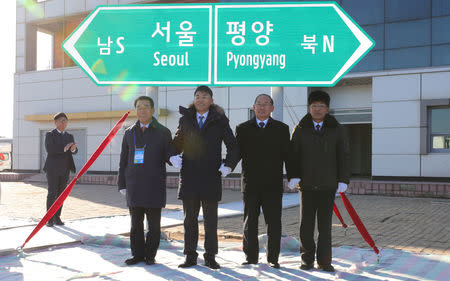 South and North Korean officials unveil the sign of Seoul to Pyeongyang during a groundbreaking ceremony for the reconnection of railways and roads at the Panmun Station in Kaesong, North Korea, December 26, 2018. Yonhap via REUTERS