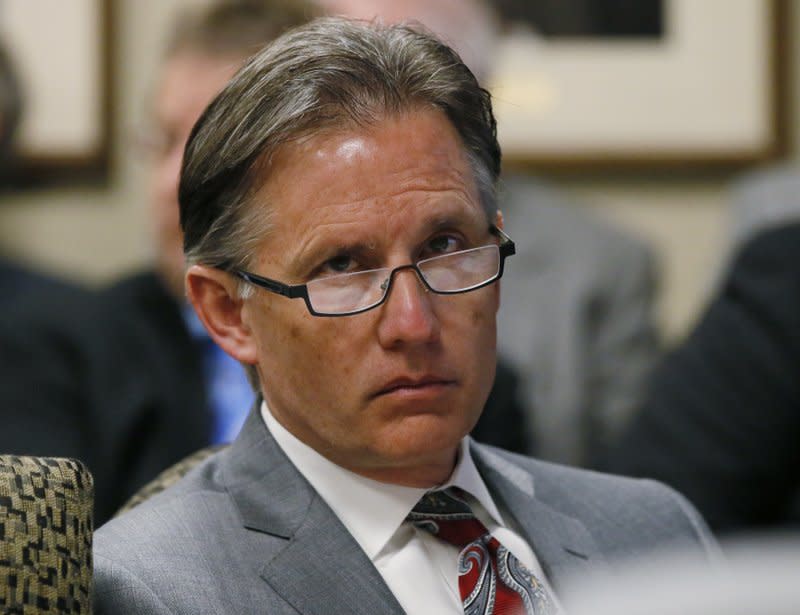 In this Feb. 21, 2017, file photo, Oklahoma Attorney General Mike Hunter sits at a meeting in Oklahoma City. (AP Photo/Sue Ogrocki, File)