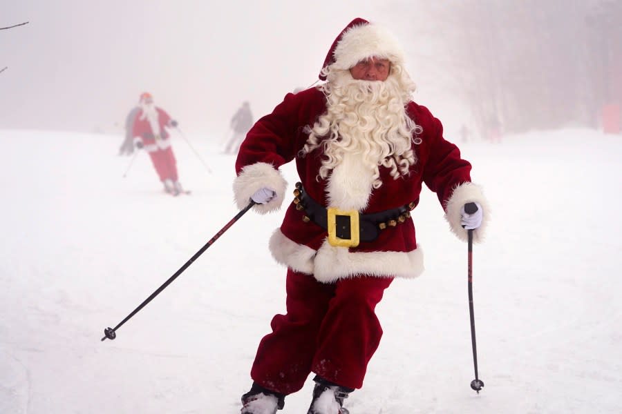 Skiers dressed as Santa Claus ski Sunday, Dec. 10, 2023, at the Sunday River ski resort in Newry, Maine. The annual Santa Sunday event raises money for local charities. (AP Photo/Robert F. Bukaty)