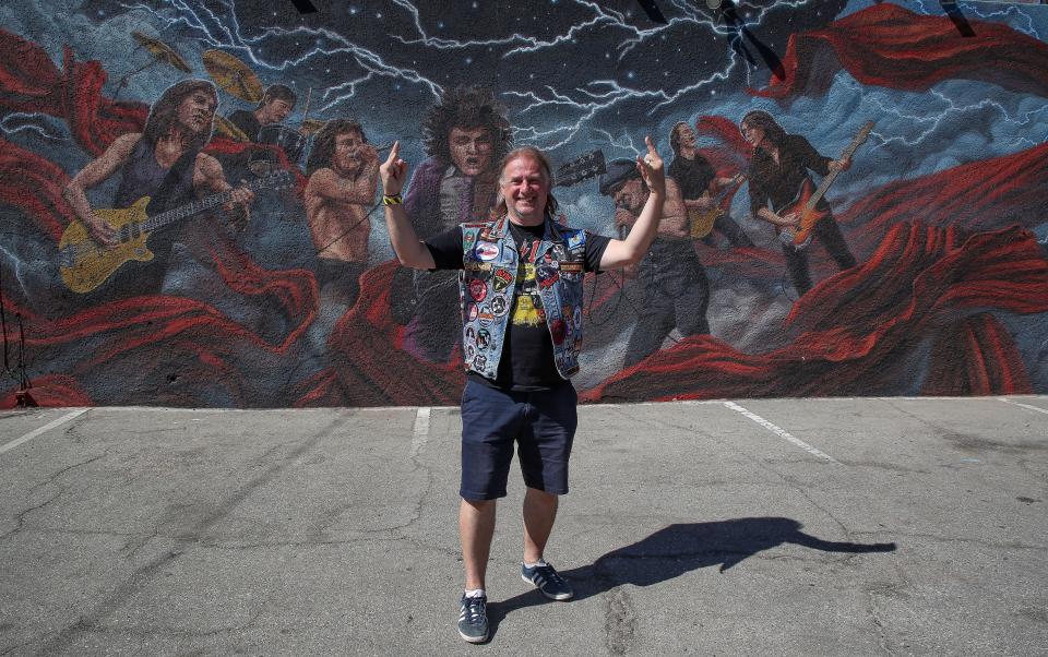 John Arnold from Somerset, England takes a photo in front of an AC/DC mural painted on the side of Club 5 which was transformed into Power Trip Pop-Up bar for the bandÕs upcoming appearance in Indio, Calif., Oct. 5, 2023.