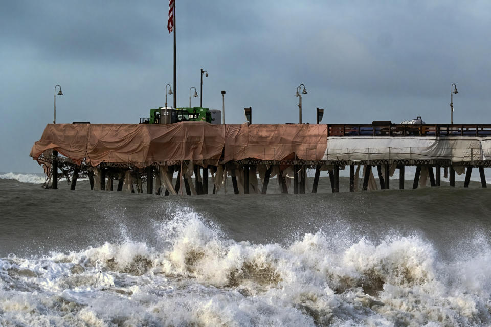 Large waves crash along the Southern California coast near the Ventura Pier in Ventura, Calif. on Saturday, Dec. 30, 2023. Since the Gold Rush, California's coast has been dotted by piers that have gone from serving steamships to becoming an integral part of many beach towns' identities, but rising seas and frequent storms due in part to climate change are threatening the iconic structures. (AP Photo/Richard Vogel)