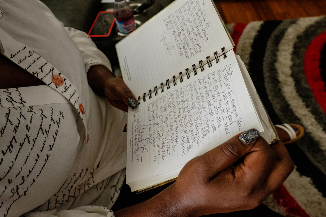 Lee holds a journal she wrote in during the time she was separated from her kids. (Stephanie Mei-Ling for NBC News and ProPublica)