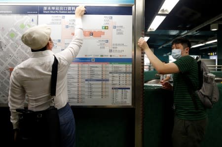 Supporters of the anti-extradition bill clean the ticket machine as part of the Sham Shui Po Station Cleaning Campaign in Hong Kong