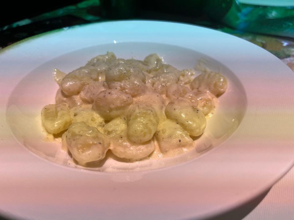 White plate of gnocchi with alfredo sauce at Le Petit Chef