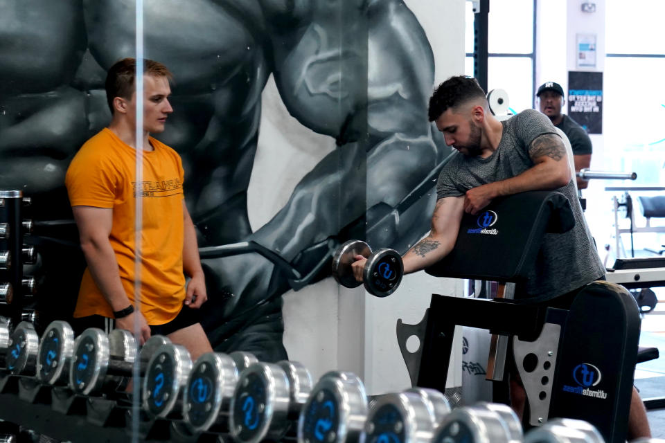 A gym member at Ultimate Fitness Gym in Birmingham gets reacquainted with a dumbell (Picture: Getty)