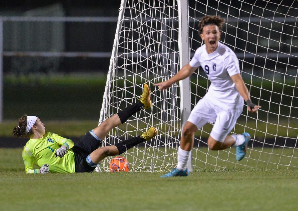 Michael Hinson (left), goal keeper for Jensen Beach High School, falls outside the goal box as Tomas Sciarra, of Gulliver Prep of Miami celebrates his team scoring in the first half of their FHSAA 4-4A quarterfinal match on Wednesday, Feb. 8, 2023, at Jensen Beach High School. Gulliver Prep won in overtime, 3-2.