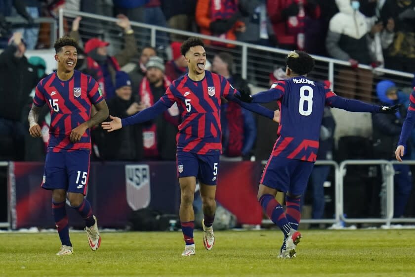 United States' Antonee Robinson (5) celebrates his goal with Weston McKennie (8) and Chris Richards (15) during the second half of a FIFA World Cup qualifying soccer match against El Salvador, Thursday, Jan. 27, 2022, in Columbus, Ohio. (AP Photo/Julio Cortez)