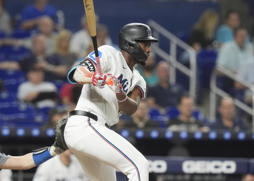 Miami Marlins' Jesús Sánchez (12) hits a single during the first inning of a baseball game against the Los Angeles Dodgers, Tuesday, Sept. 17, 2024, in Miami. (AP Photo/Marta Lavandier)