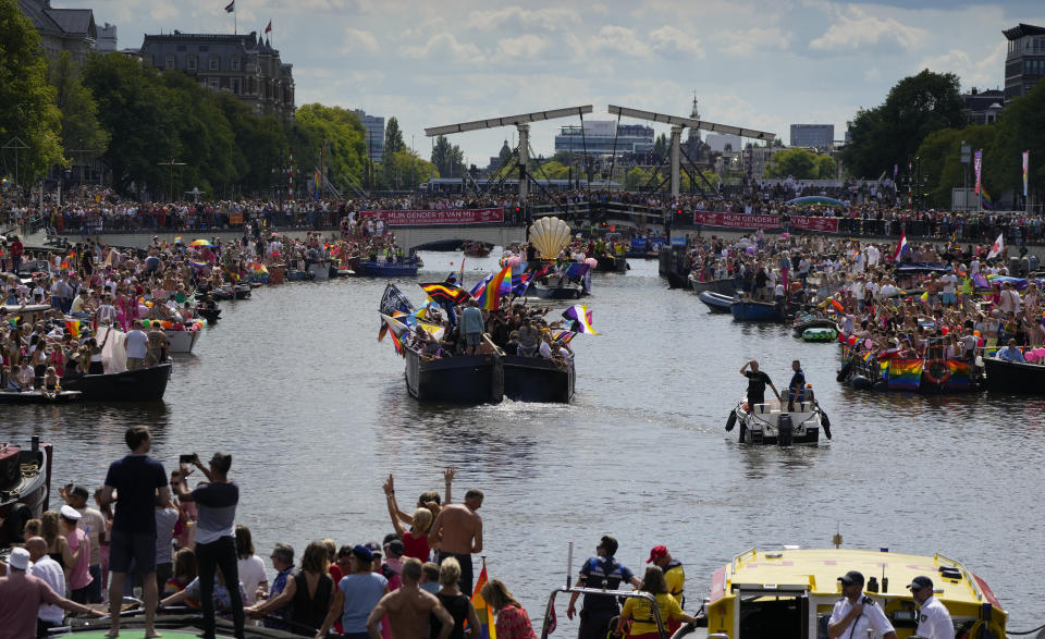 Hundreds of thousands of people lined canals in the Dutch capital to watch the colorful spectacle of the Pride Canal Parade return for the 25th edition after the last two events were canceled due to the COVID-19 pandemic, in Amsterdam, Netherlands, Saturday, Aug. 6, 2022. (AP Photo/Peter Dejong)