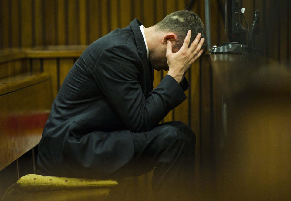 Oscar Pistorius cradles his head in his hands as he listens to forensic evidence being given in court in Pretoria, South Africa, Thursday, April 17, 2014. Pistorius is charged with the murder of his girlfriend, Reeva Steenkamp, on Valentines Day in 2013. (AP Photo/Alet Pretorius, Pool)