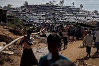 Rohingya refugees walk through a camp in Cox's Bazar, Bangladesh, September 25, 2017. REUTERS/Cathal McNaughton