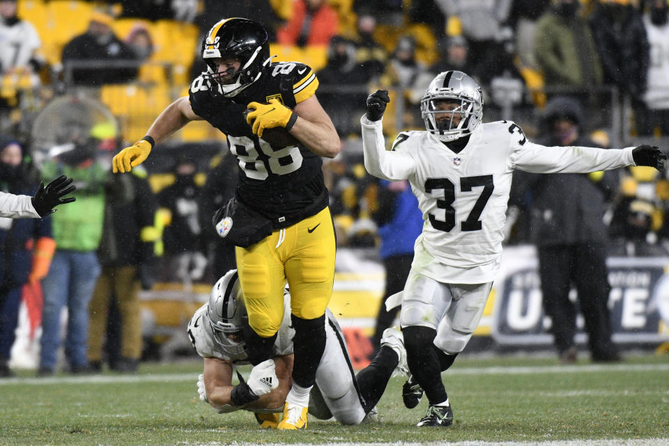 Pittsburgh Steelers tight end Pat Freiermuth (88) runs after a catch with Las Vegas Raiders cornerback Tyler Hall (37) defending during the second half of an NFL football game in Pittsburgh, Saturday, Dec. 24, 2022. (AP Photo/Don Wright)