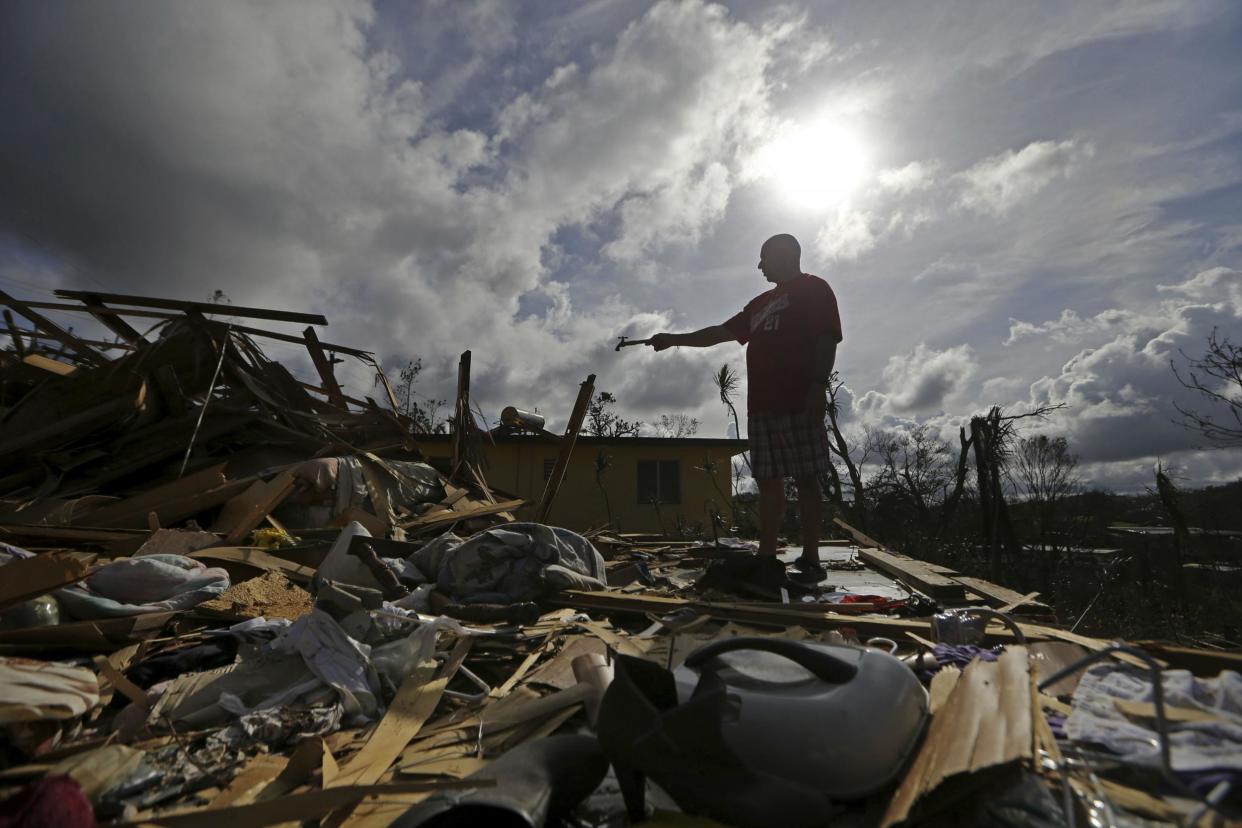 A Puerto Rican man amid the remains of his destroyed home in Aibonito, Puerto Rico on Monday, Sept. 25, 2017. Mr Trump plans to visit the island: AP