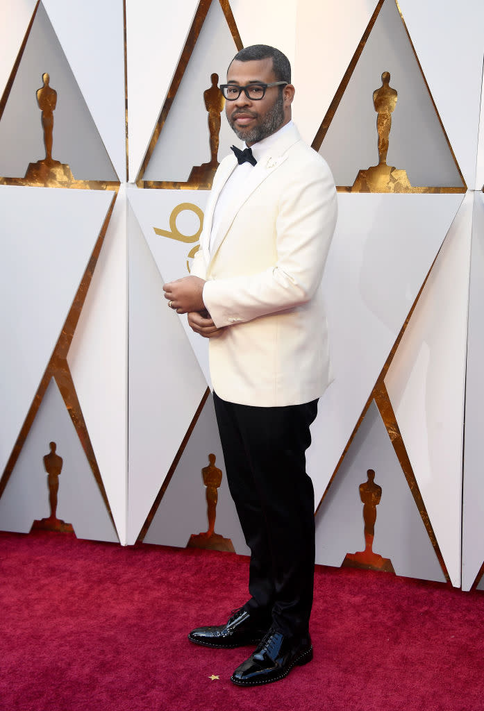 <p>Jordan Peele, writer and director of <em>Get Out</em>, suited up for his big night. Peele certainly had love from cast member Bradley Whitford heading into the ceremony, when he told Ryan Seacrest that “What Jordan did was a miracle.” (Photo: Getty Images) </p>