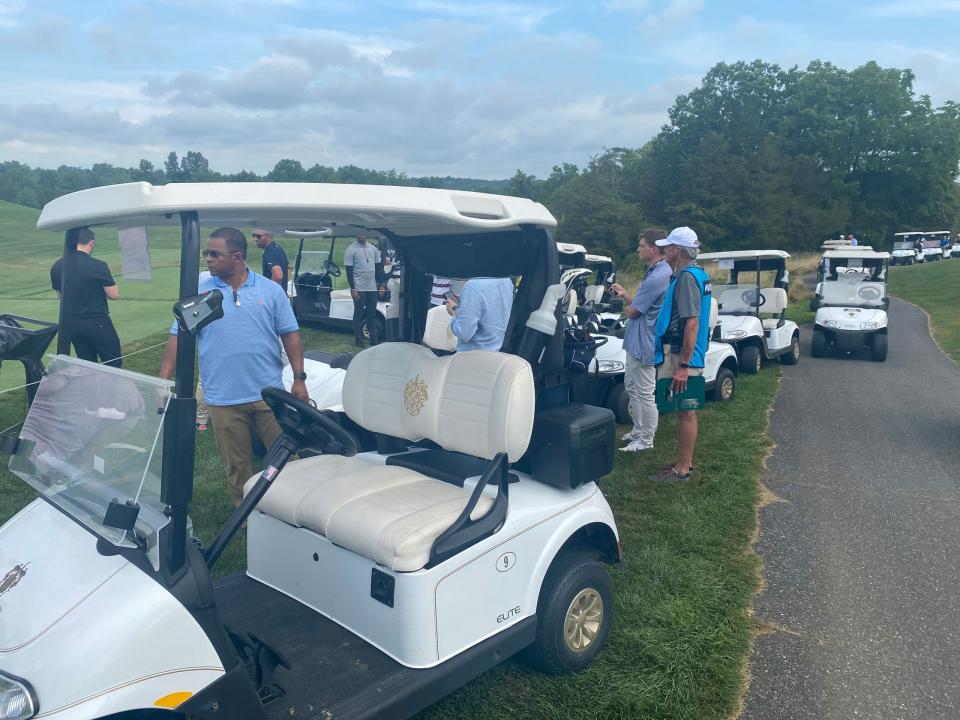 A long line of golf carts follows as former President Trump plays his round.