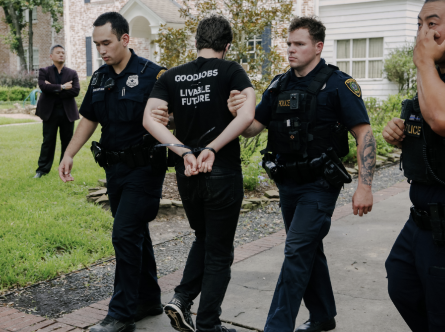 Young people protesting the climate crisis at the home of Republican Senator Ted Cruz in Texas are led away by police on Monday (Rachael Warriner)
