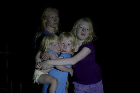 The four sisters, from L-R, Donilcia, Iveily, Yaisseth and Jade Morales, who are part of the albino or "Children of the Moon" group in the Guna Yala indigenous community, pose for a photograph on Ustupu Island in the Guna Yala region, Panama April 24, 2015. REUTERS/Carlos Jasso