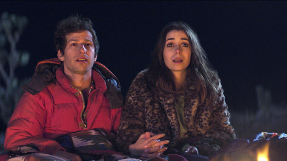 This image released by Hulu shows Andy Samberg, left, and Cristin Milioti in a scene from the film "Palm Springs." (Hulu via AP)