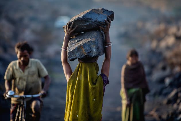 A female worker has piled coal on her head while she is working in Jharia coal field where a large amount of indias coal is mined. (Photo: Jonas Gratzer via Getty Images)