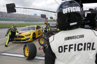 A race official looks on as Matt DiBenedetto makes a stop on pit road during a NASCAR Cup Series auto race at Kansas Speedway in Kansas City, Kan., Sunday, May 2, 2021. (AP Photo/Colin E. Braley)