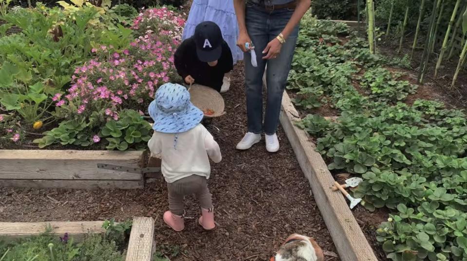 <p>In another snippet from their Netflix documentary, Archie wears a baseball cap with 'A' on it as he gardens with his sister.</p>