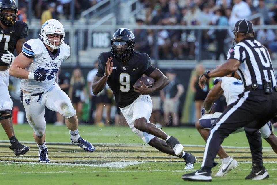 Sep 16, 2023; Orlando, Florida, USA; UCF Knights quarterback Timmy McClain (9) runs the ball during the first quarter against the Villanova Wildcats at FBC Mortgage Stadium. Mandatory Credit: Mike Watters-USA TODAY Sports