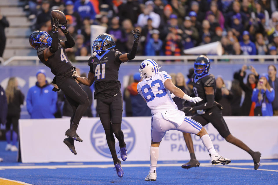 Boise State safety Rodney Robinson (4) catches the ball for an interception on a throw to BYU tight end Isaac Rex (83) in front of Boise State cornerback Jaylen Clark (41) in the first half of an NCAA college football game, Saturday, Nov. 5, 2022, in Boise, Idaho. (AP Photo/Steve Conner)