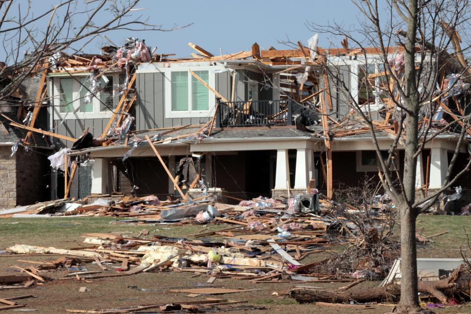 Damage to homes and businesses by Wednesday's tornado is seen on Thursday in Cole.