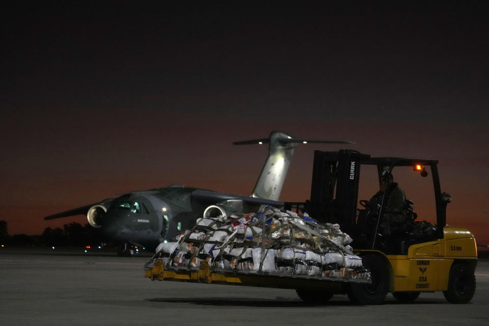 Military prepare to load supplies on an Air Force plane, to transport to victims and people who lost their homes from floods caused by heavy rains in the cities of the Rio Grande do Sul state, at the Air Base in Brasilia, Brazil, Saturday, May 11, 2024. (AP Photo/Eraldo Peres)